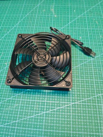 Front view of the black single USB cooling fan showing the circular wire guard and attached USB-A cable