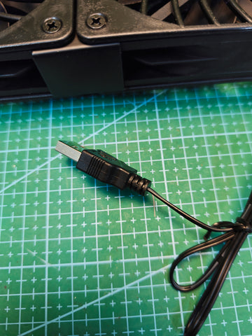USB-A power plug on the black dual cooling fan unit
