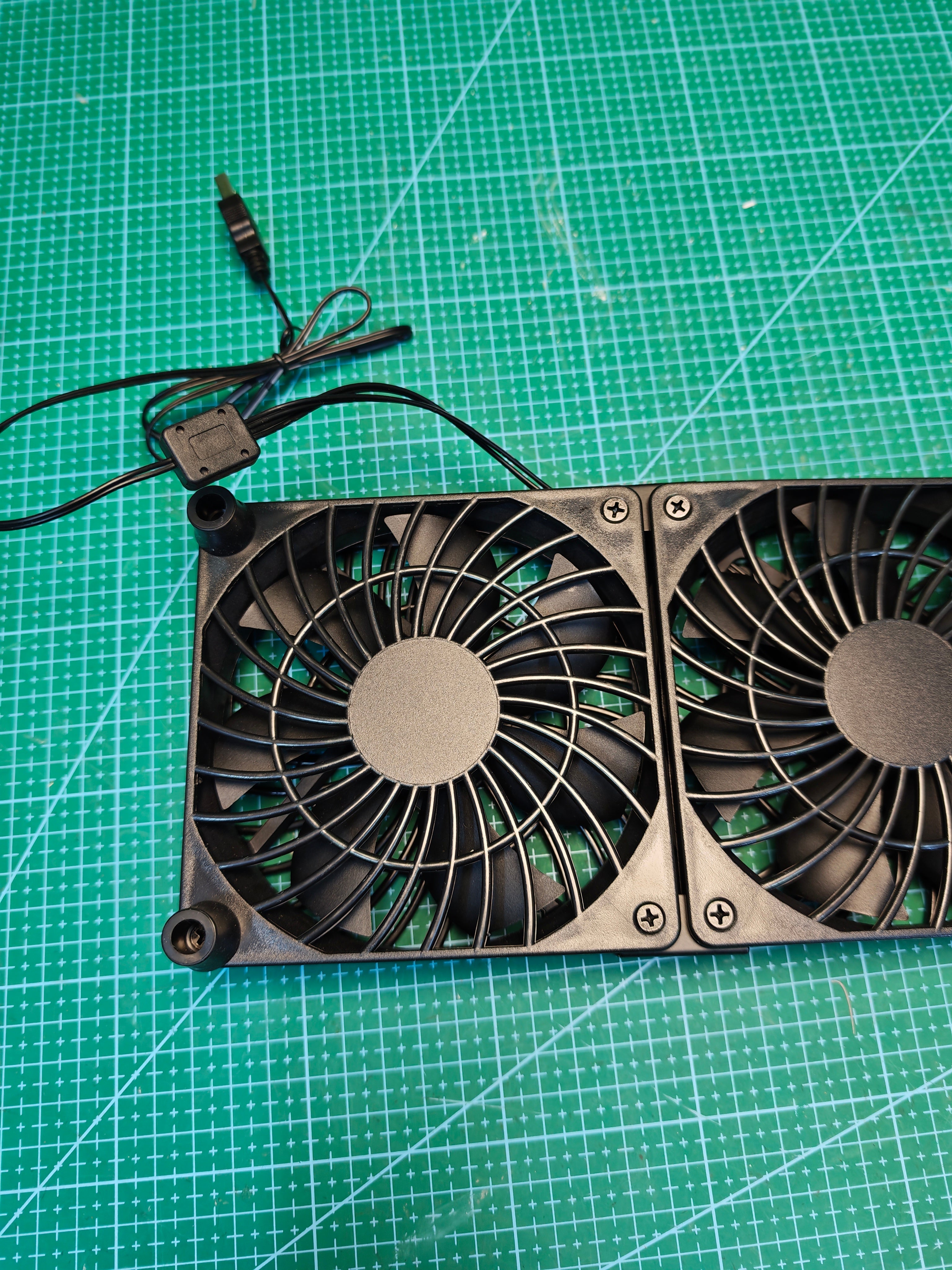 Rear view of the dual USB cooling fan unit, left fan and corner feet