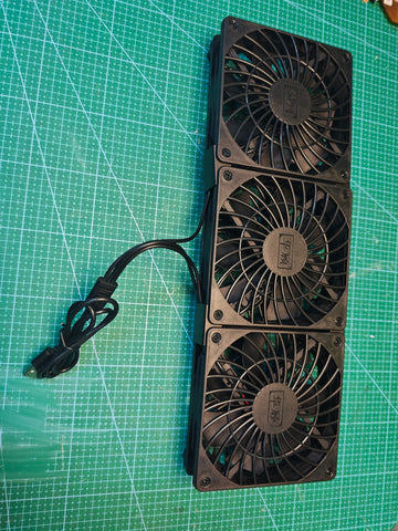Front view of the black triple USB cooling fan unit with attached USB-A cable