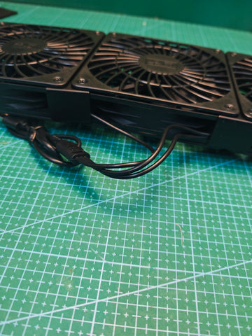 Side view of the triple USB cooling fan unit showing the joined frame and attached cable