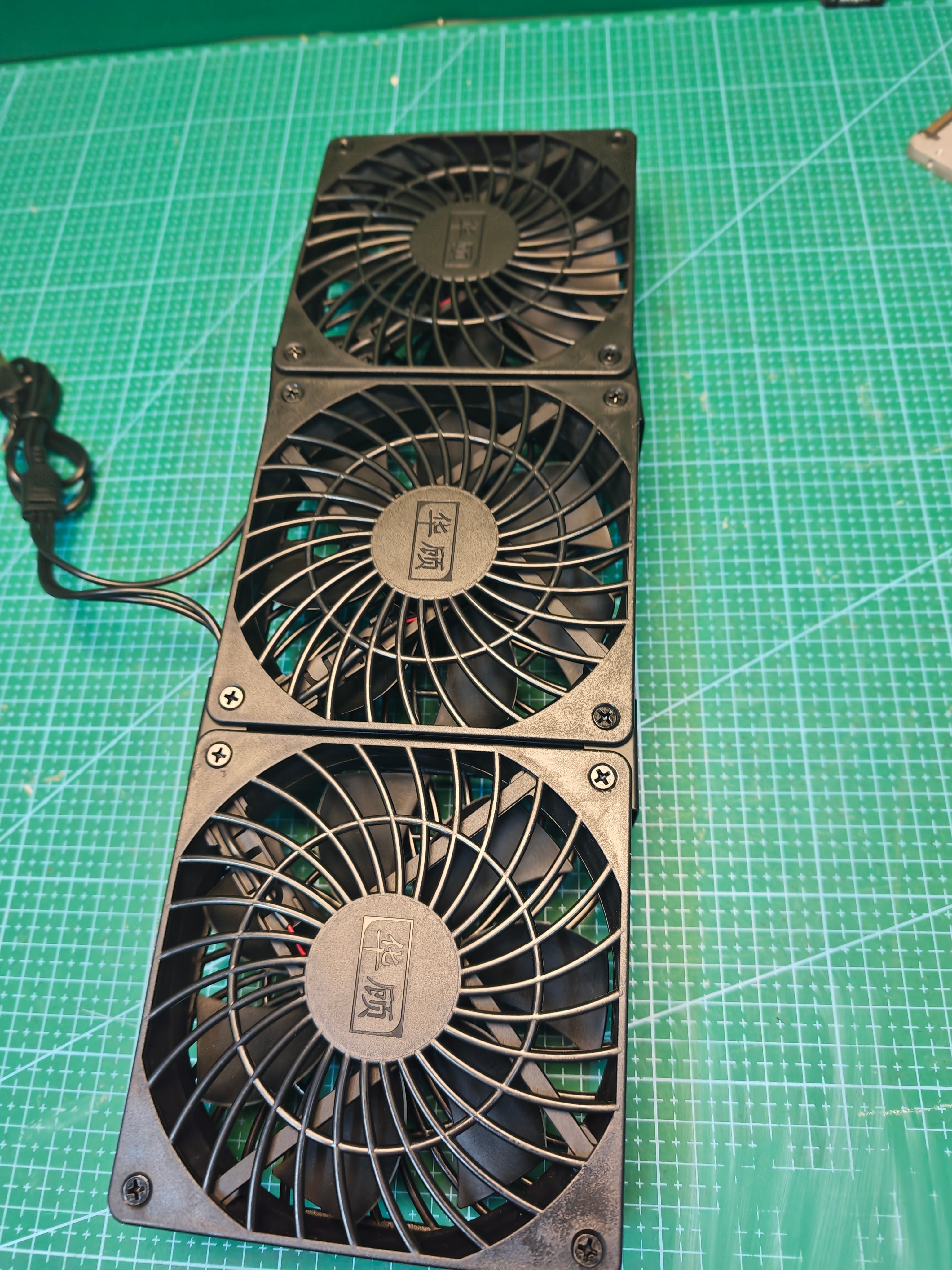Alternate front view of the black triple USB cooling fan unit